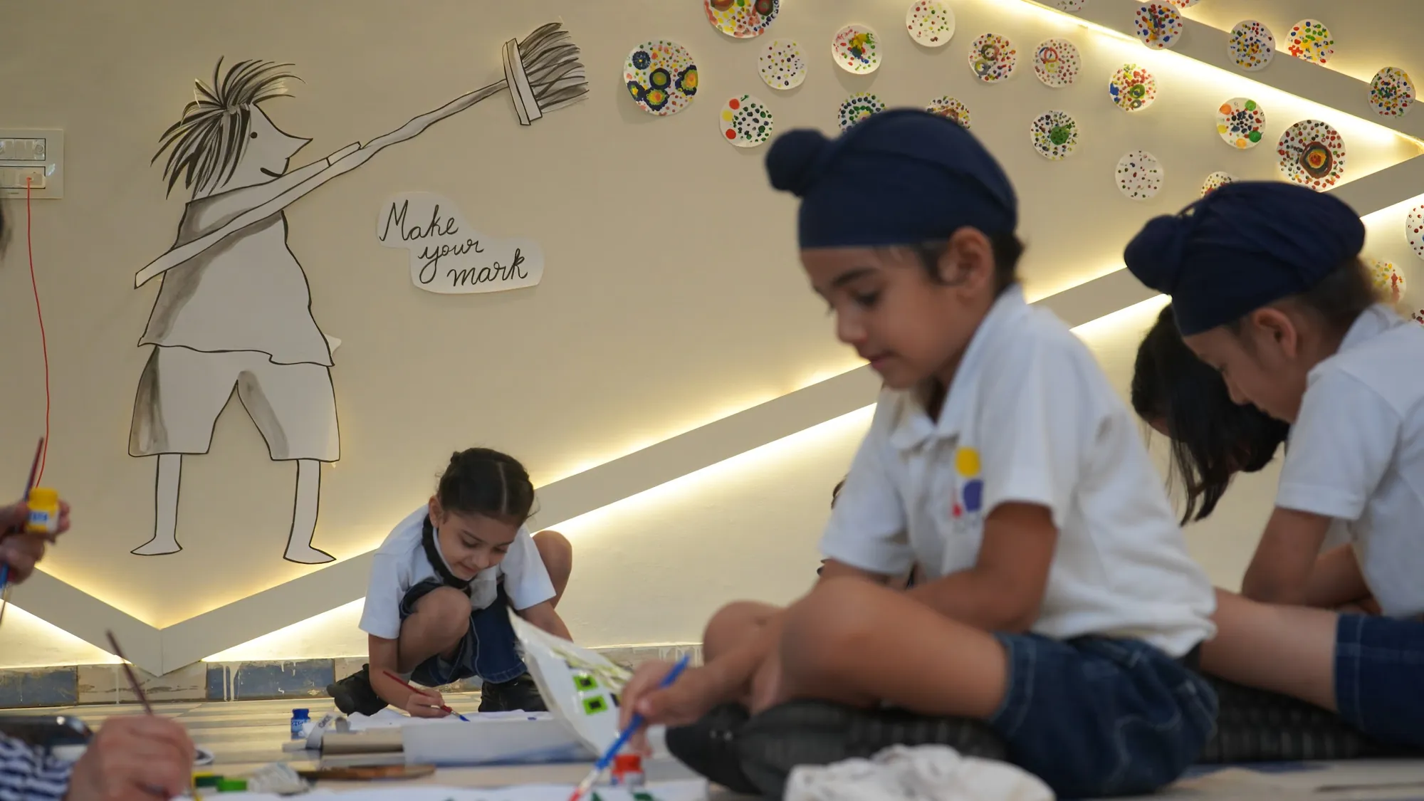 Students painting together on the floor of the art space