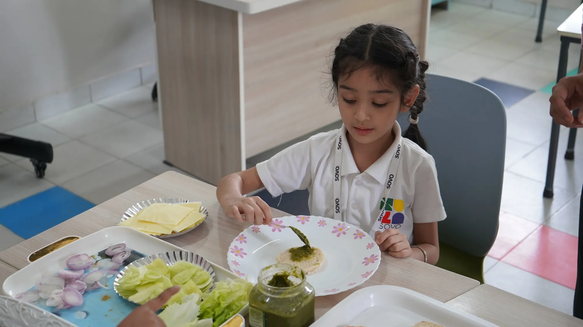 A student preparing a fresh, sugar-free snack at her table
