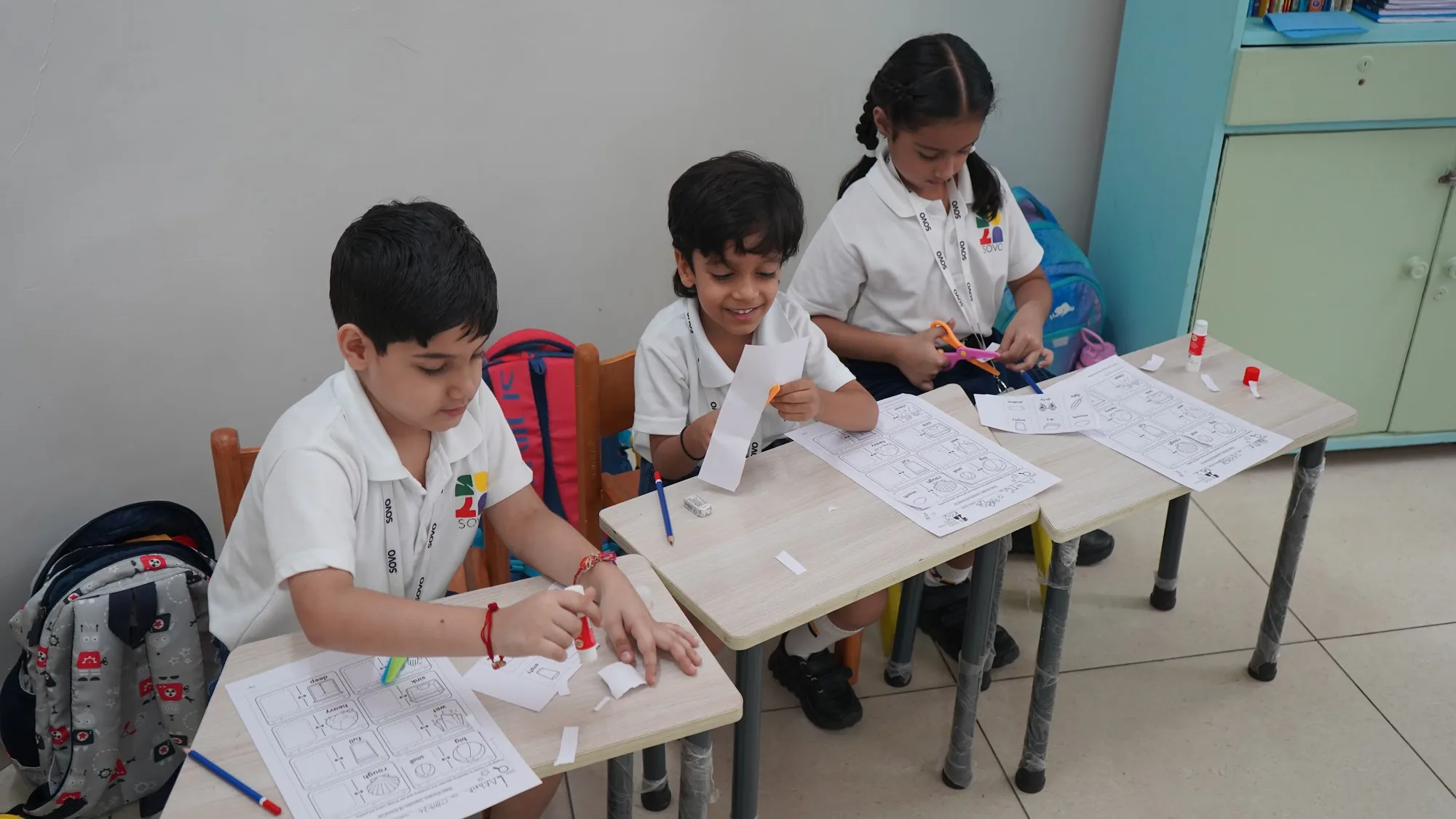 Students working on worksheets at their classroom desks