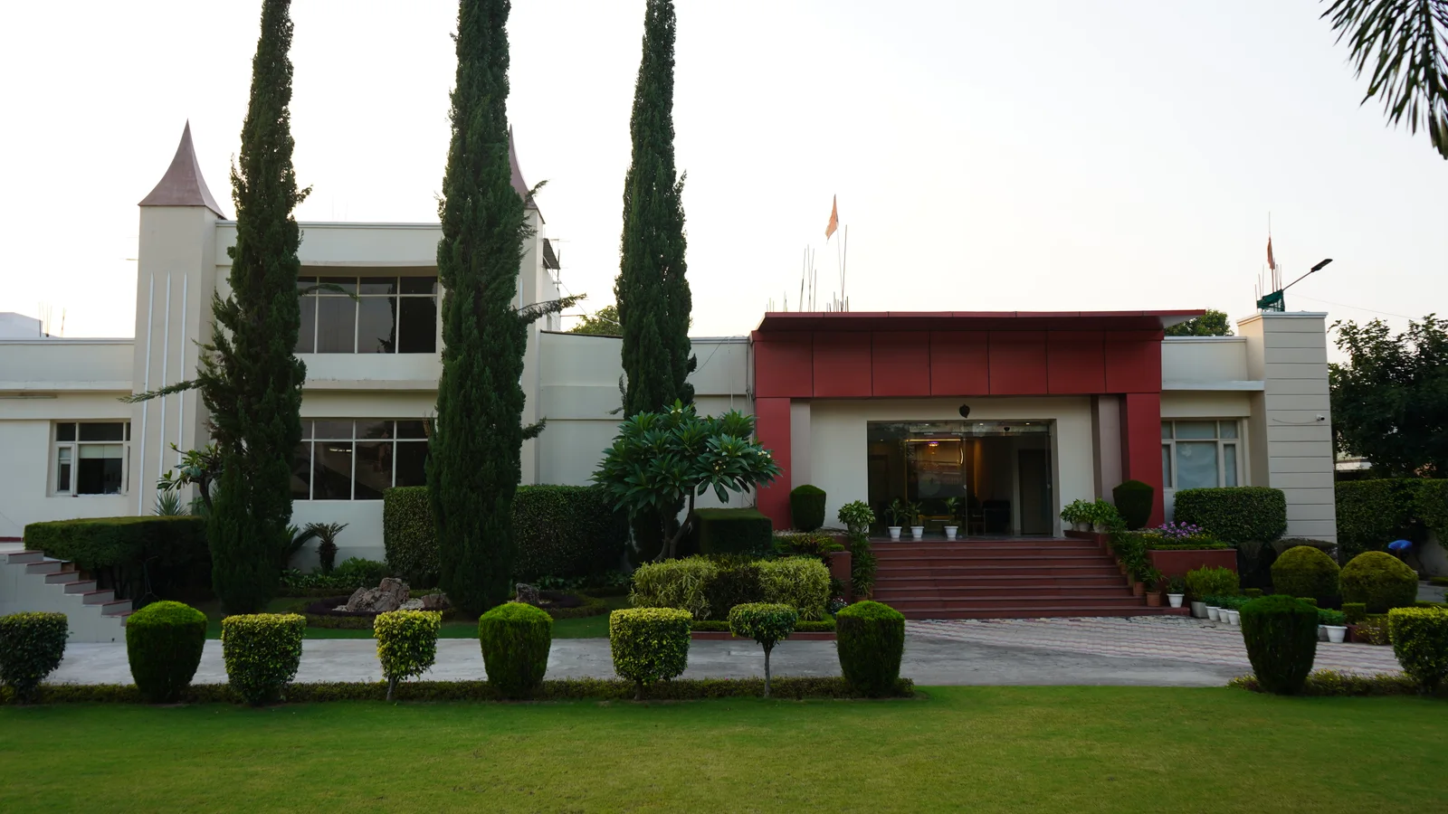 The Panchkula school building with a lawn and tall trees outside