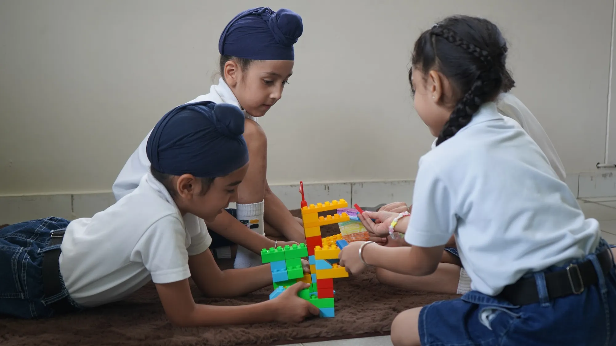 Students building and testing a tower of interlocking blocks